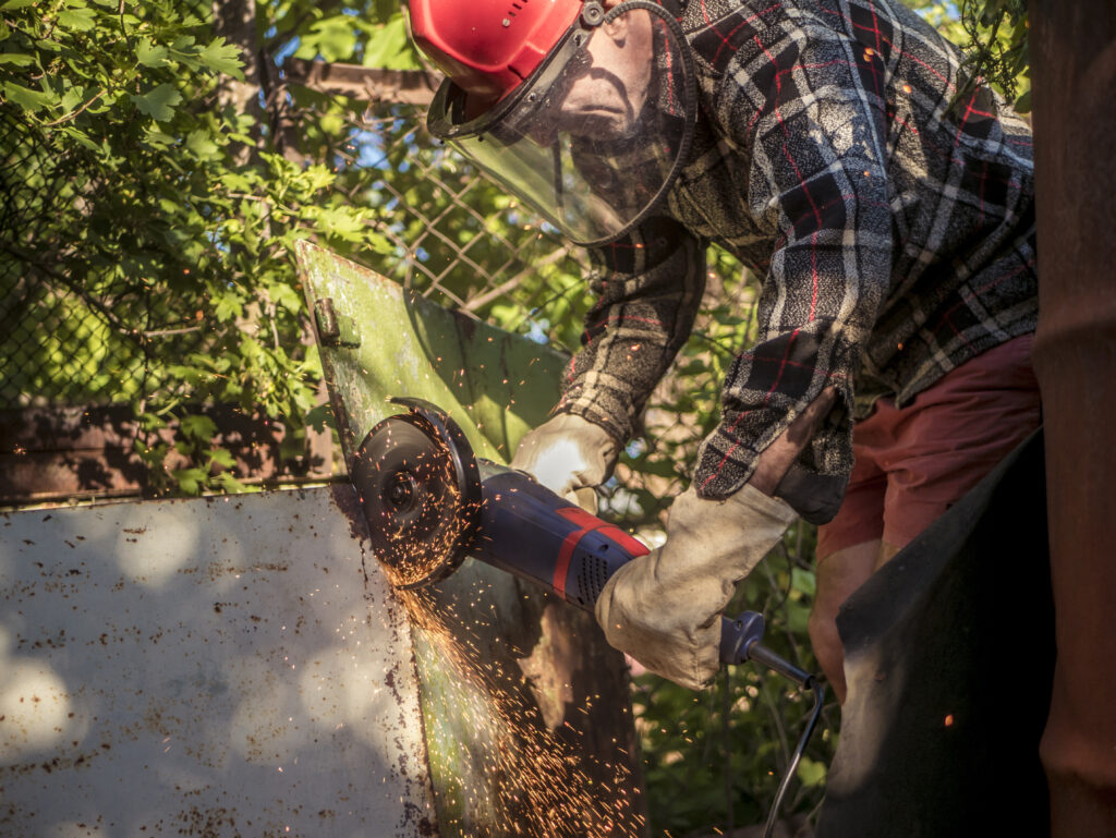 Angle Grinder Safety for Safer Work Every Day 2 craftsman cutting metal with power tool outdoors 2026 09 21 14 03 28 utc